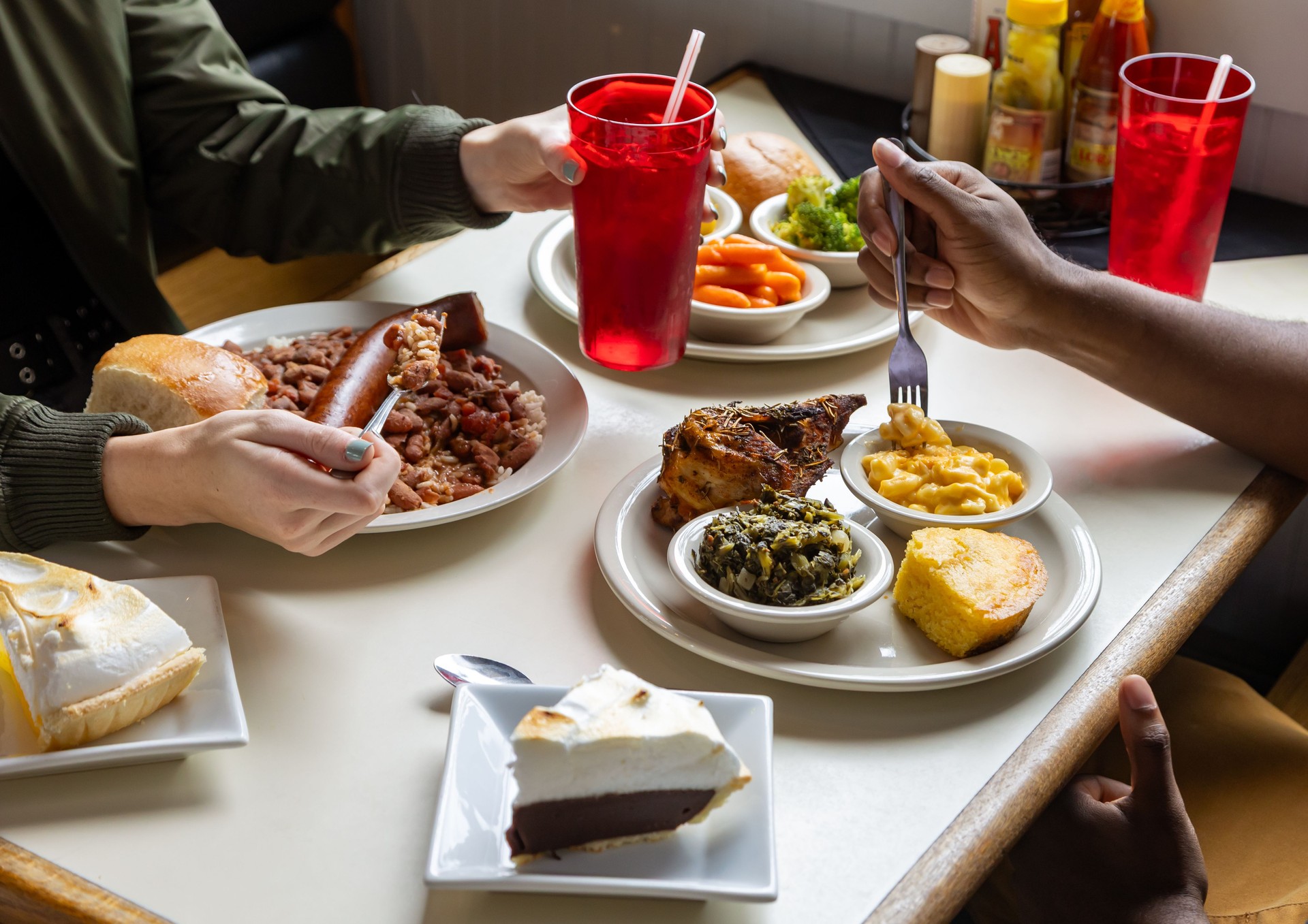 Southern food on table while people share a meal